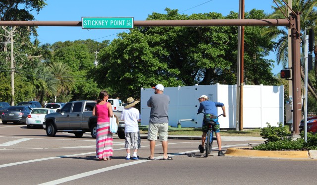 Pedestrians and a cyclist stop mid-crossing of Stickney Point Road as traffic turns right onto Midnight Pass Road. Photo by Rachel Hackney
