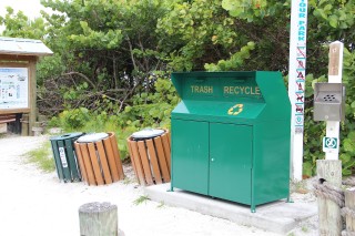 A combination garbage/recycling receptacle stood at Beach Access 5 on Siesta Key in the spring of 2014, next to signage about county park rules. Photo from the News Leader archive