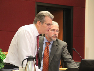 Howard Berna (right) assists Attorney William Merrill with the visual equipment before the meeting. Rachel Hackney photo
