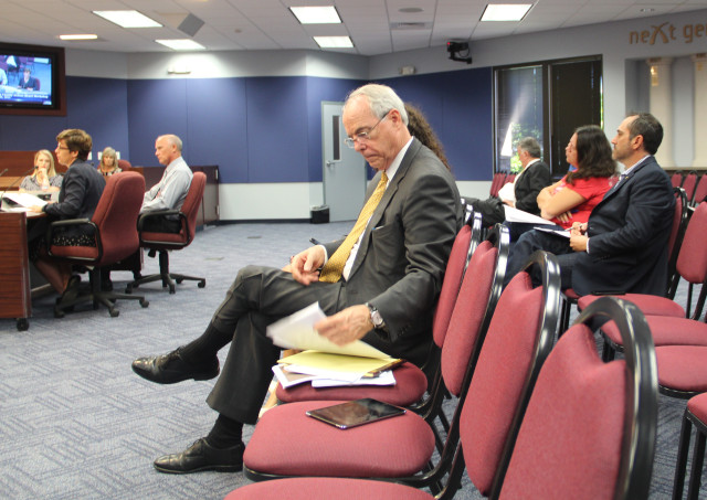 Pat Neal of Neal Communities (front row) and County Commissioner Paul Caragiulo (behind Neal) listen to board workshop discussion on Oct. 20. Rachel Hackney photo