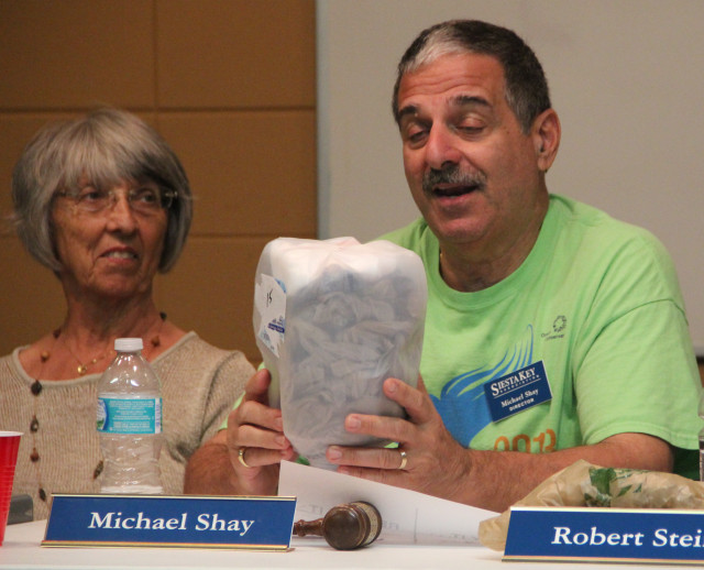 Joyce Kouba listens as Michael Shay explains her recycled milk jug idea. Rachel Hackney photo
