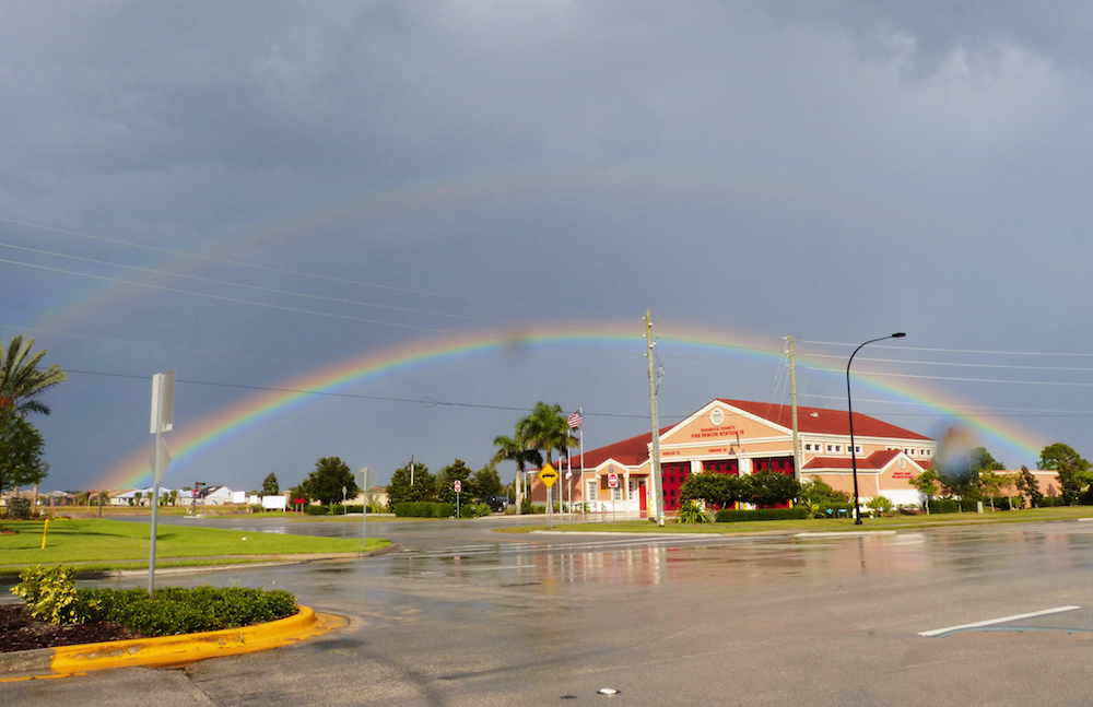 The fire station on Honore Road is framed in a late day rainbow.