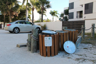 Recycling bins stand at Beach Access 5 just outside Siesta Village. File photo