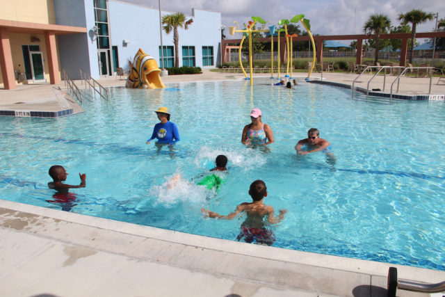 Melon Dash, CEO of the Miracle Swimming program based in Sarasota (left, in the water) leads a youth swimming instruction class in the Robert Taylor Complex pool in 2013. File photo