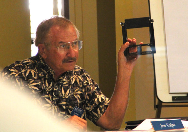 Joe Volpe holds up the type of container the SKA plans to use. Rachel Hackney photo