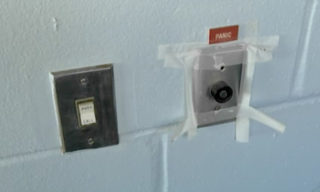 Tape holds a panic button to the wall in one section of the jail. Image courtesy Sheriff's Office