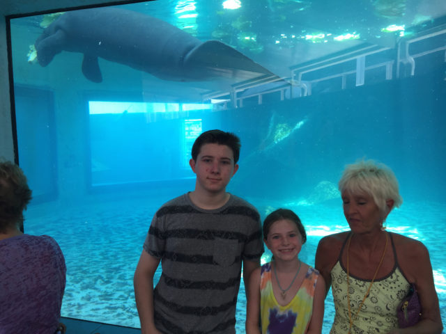 Skyler, Keylee and Michelle gather for a group photo with a manatee at Mote Aquarium. Photo courtesy of Steve Wall