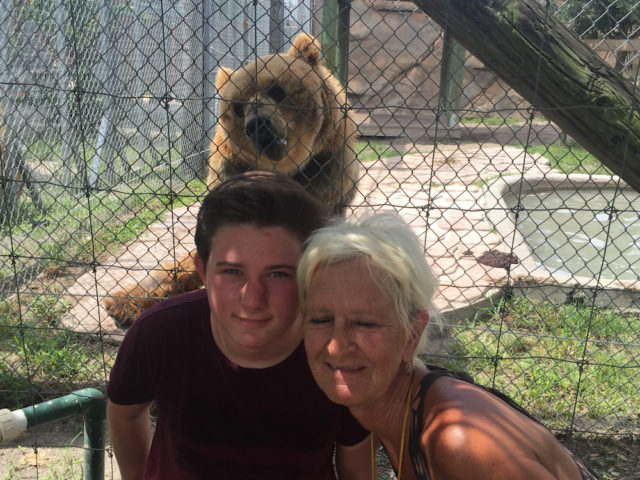 Skyler and his grandmother pose with one of the well known residents of Big Cat Habitat. Photo courtesy of Steve Wall
