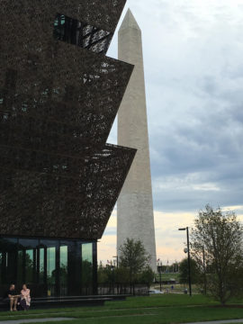 The Washington Monument stands behind the new African American Museum. Photo by Stan Zimmerman