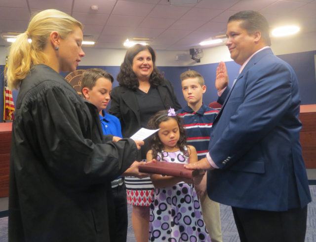 In the company of family members — son Johnny, wife Christine, daughter Madison and son E.J. — Eric Robinson (right) is sworn in by Judge Erika Quartermaine. Contributed photo
